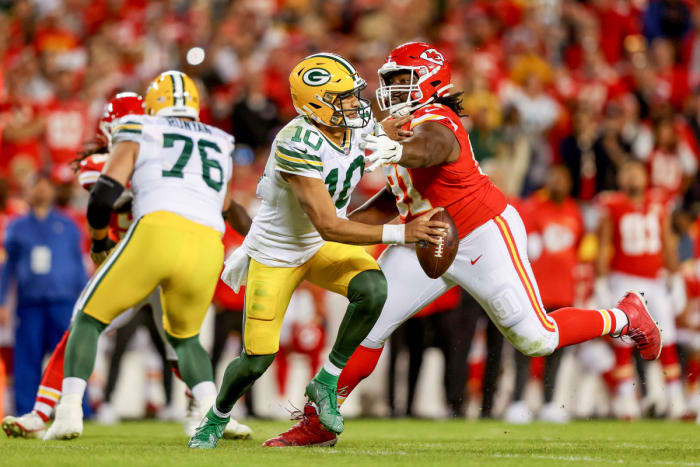 Jordan Love tries to evade a pass rusher from the Chiefs